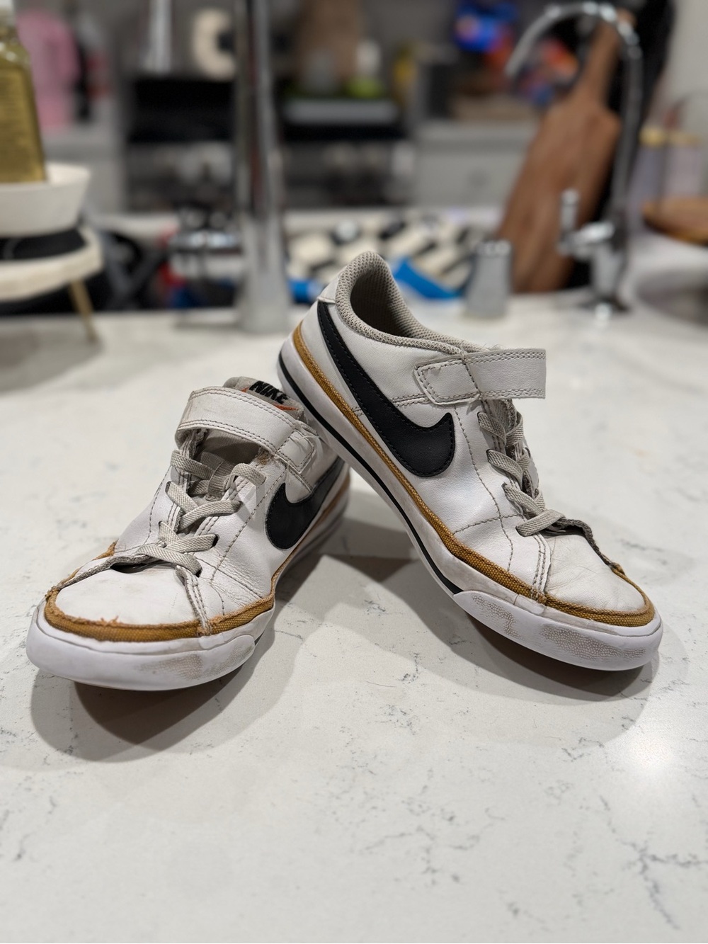 Nike Kids White Sneakers with Black Swoosh and Gold Trim